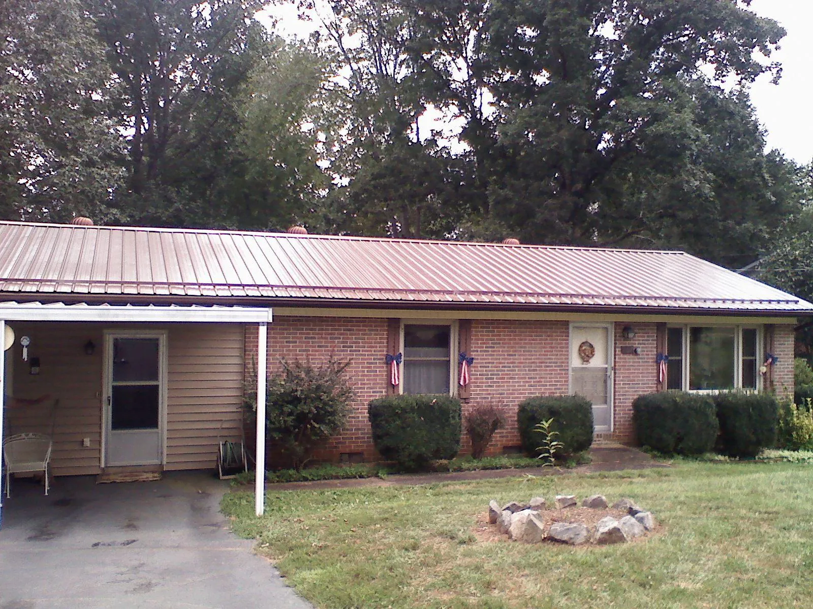 Bronze metal roof and carport on a brick ranch home — Roof Repair work by our crew in Spring Run